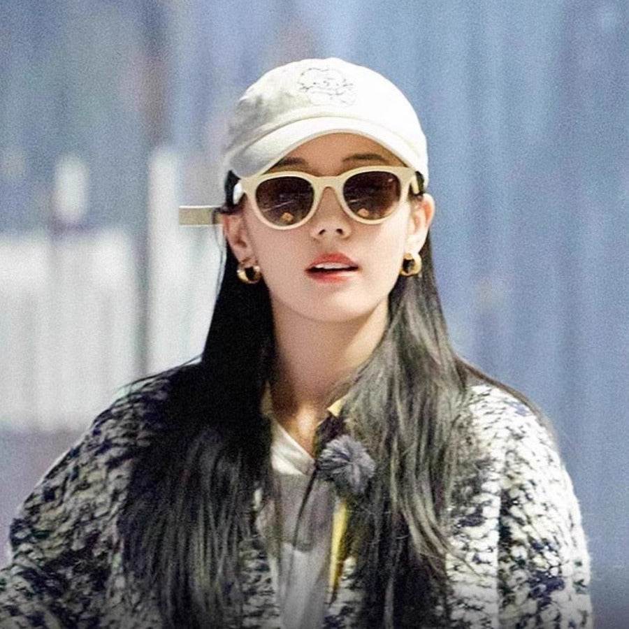 A woman wearing cat-eye sunglasses - Price Value Store